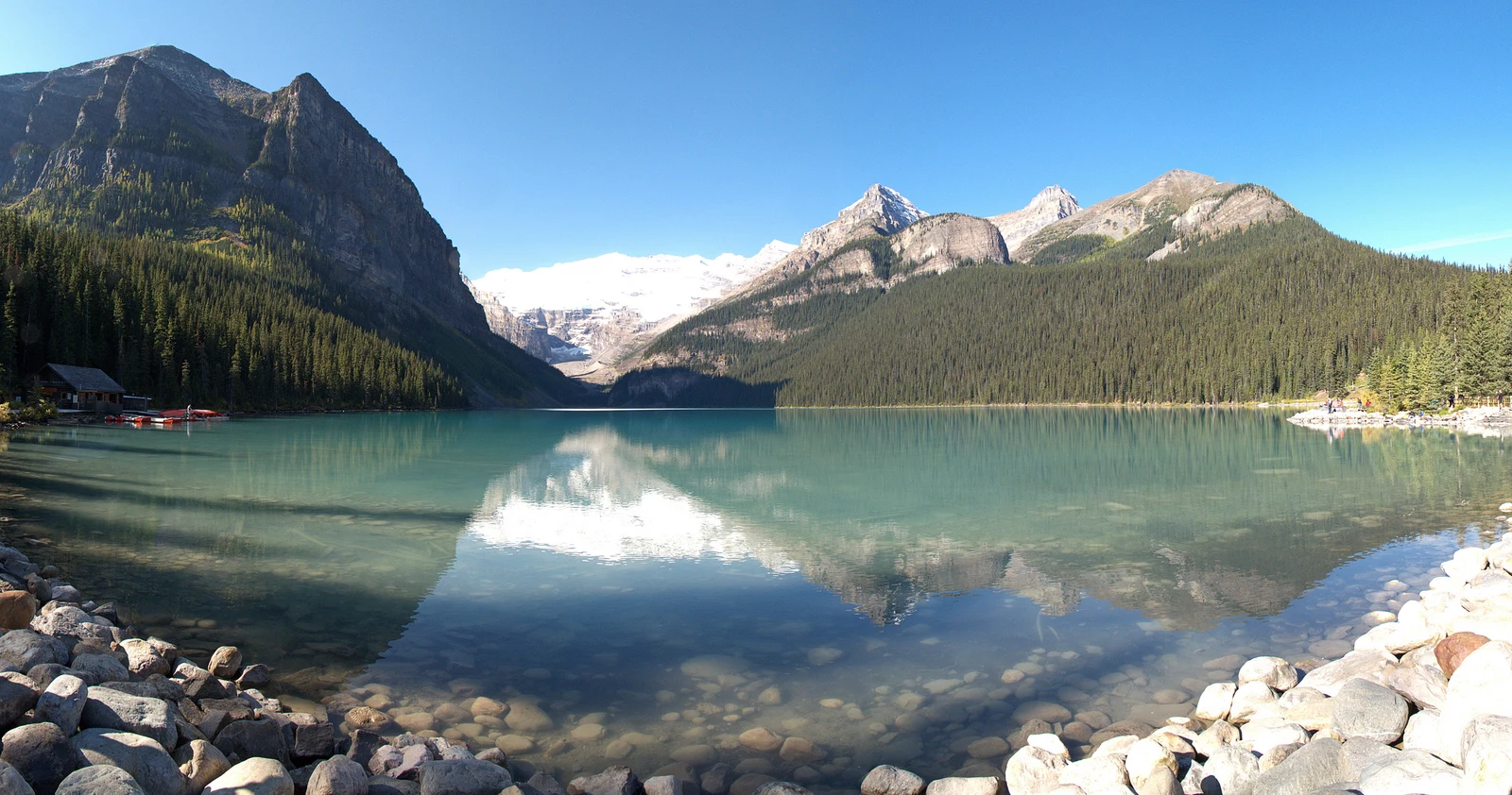 Turquoise glacial lake surrounded by mountains near Lake Louise
